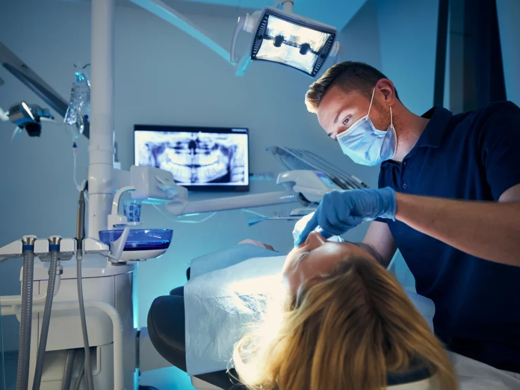 Dentist performing an oral surgery